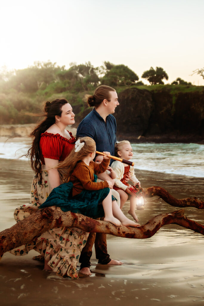 A styled family photography session on the beach, with matching outfits and playful, connected moments by the ocean - Paula Jane Photography