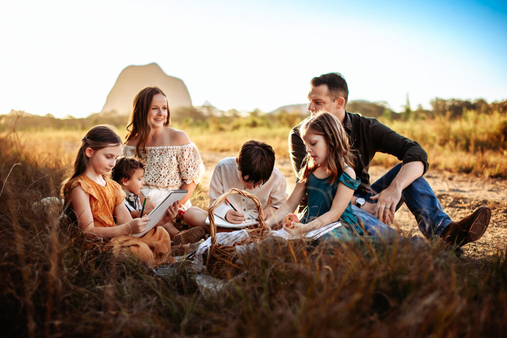 A family enjoying an outdoor photoshoot in soft natural light, capturing joyful moments and connection. Part of “5 Gifts Your Family Will Love This Christmas.”
